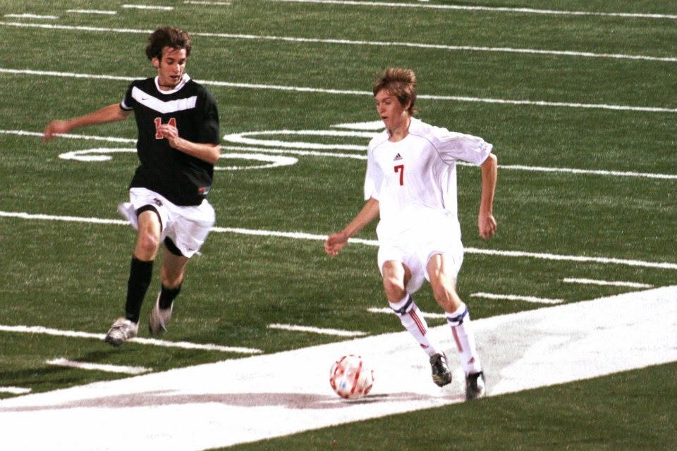Dr. Stephens carrying the ball up the wing during a soccer match