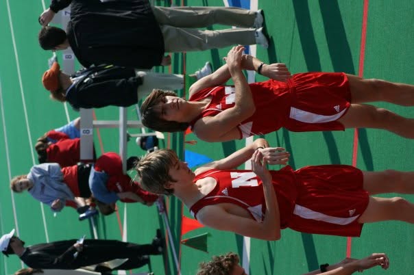Dr. Stephens and a teammate checking their watches trackside